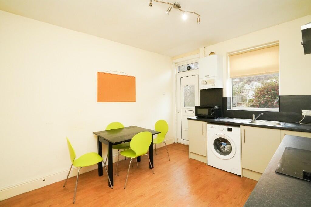 Bright and modern kitchen featuring light wood ...