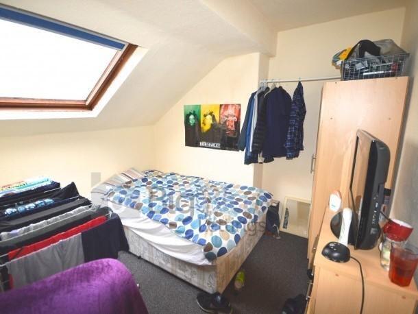 A cozy attic bedroom featuring a skylight windo...