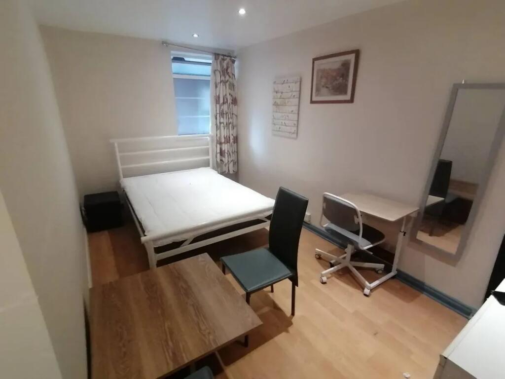 A tidy and practical double bedroom featuring a...