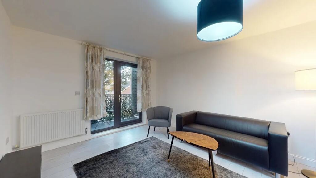 Bright and modern living room featuring a sleek...