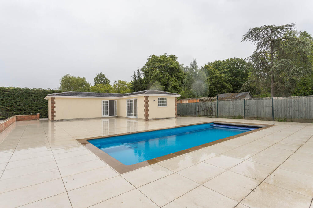 Swimming Pool with large paved patio area