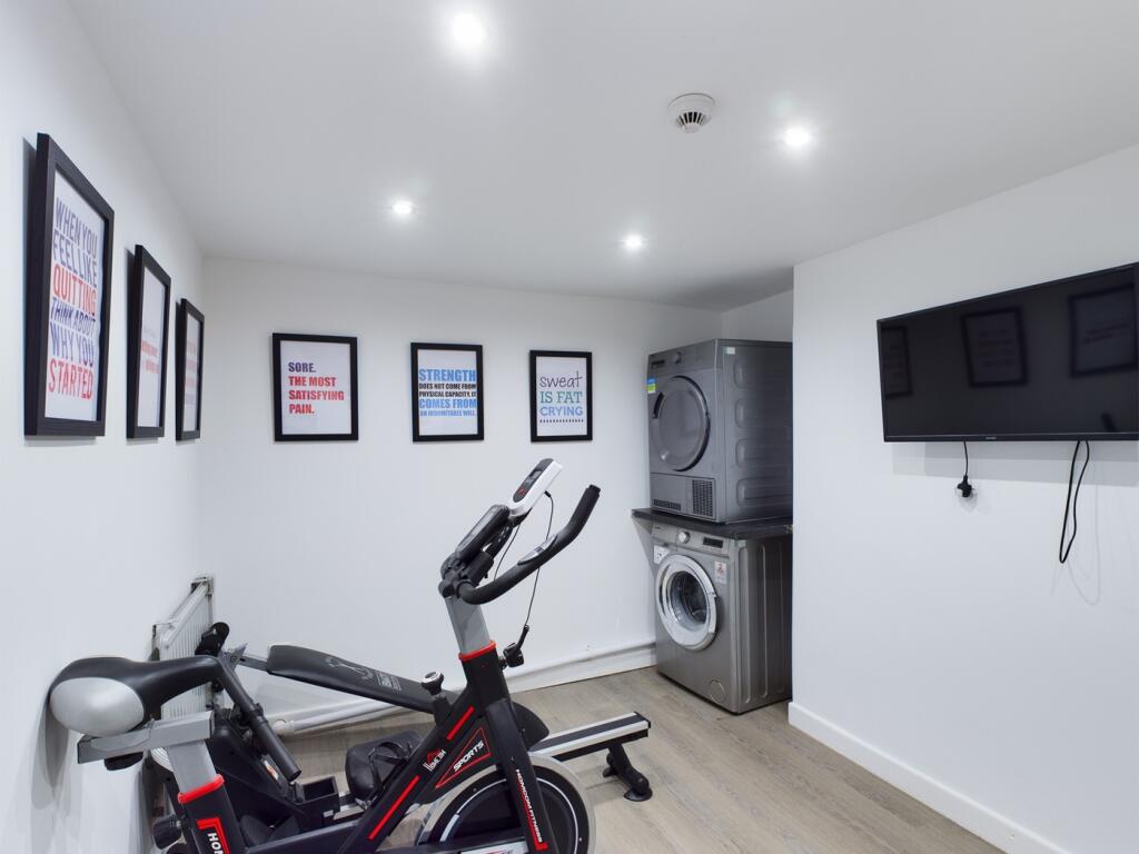 A bright and clean gym area with modern equipme...