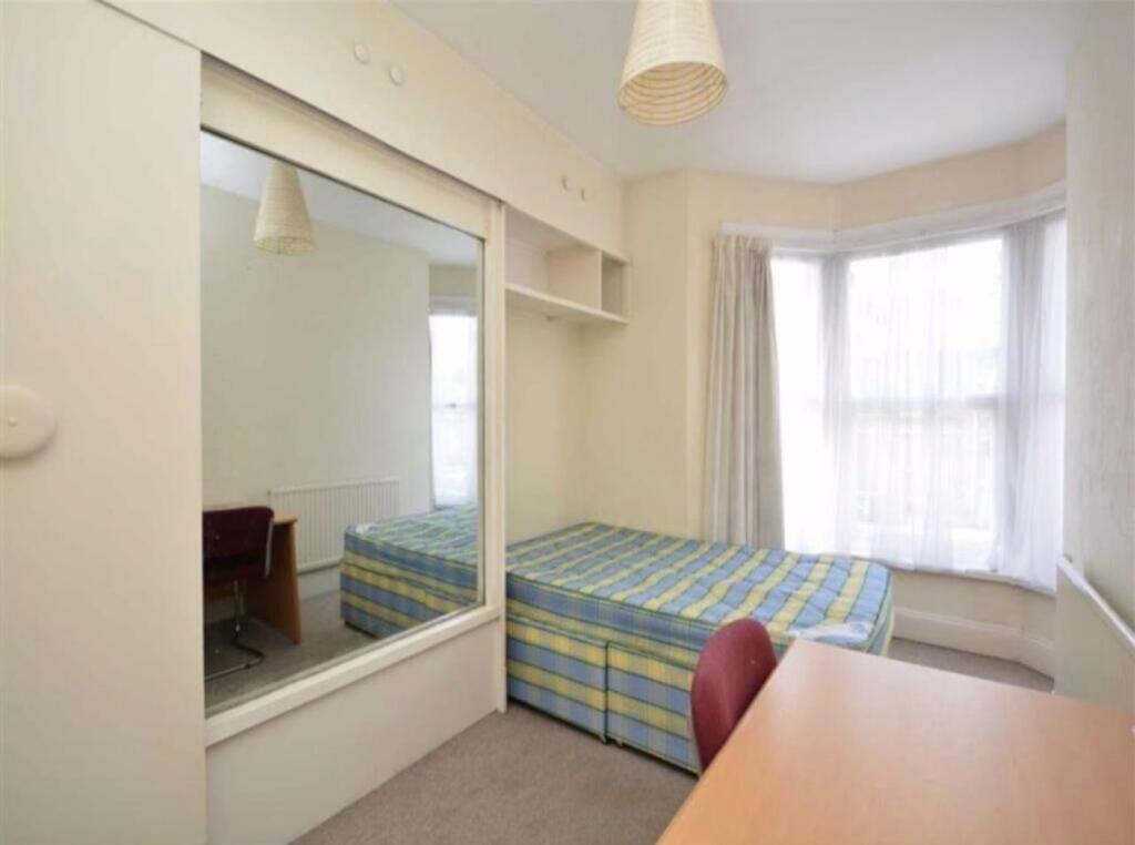 A bright and inviting double bedroom featuring ...