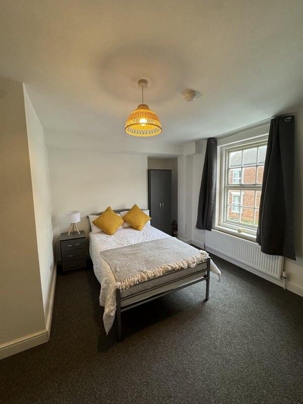 Bright and cozy double bedroom featuring a comf...