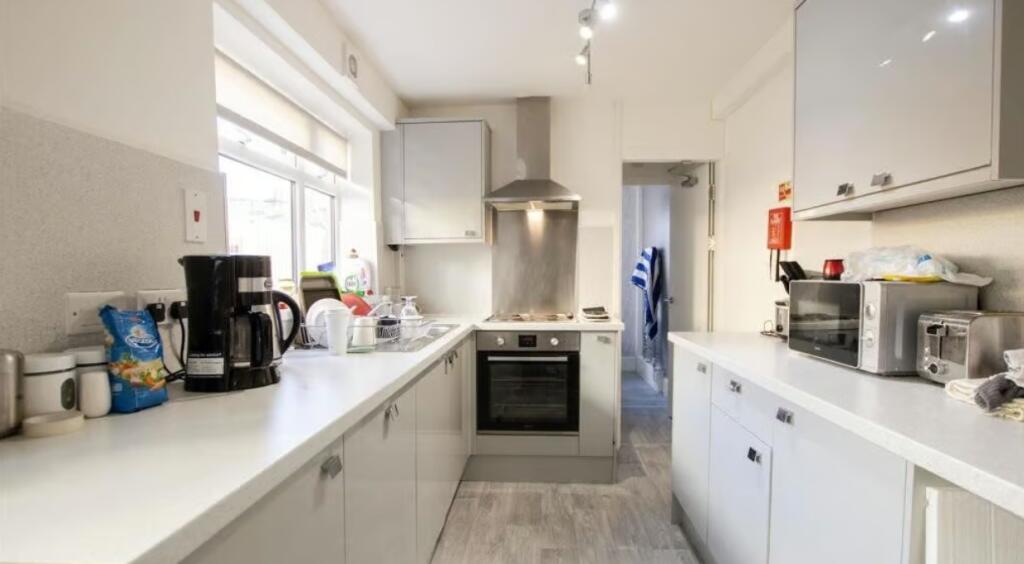 Bright and modern kitchen featuring ample count...