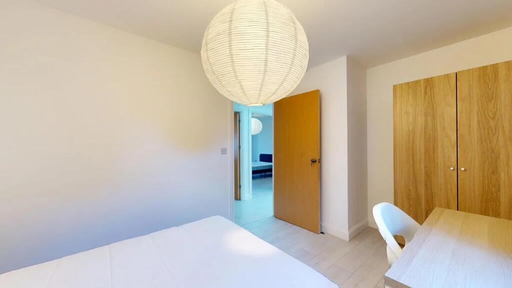 A bright and tidy double bedroom featuring a co...