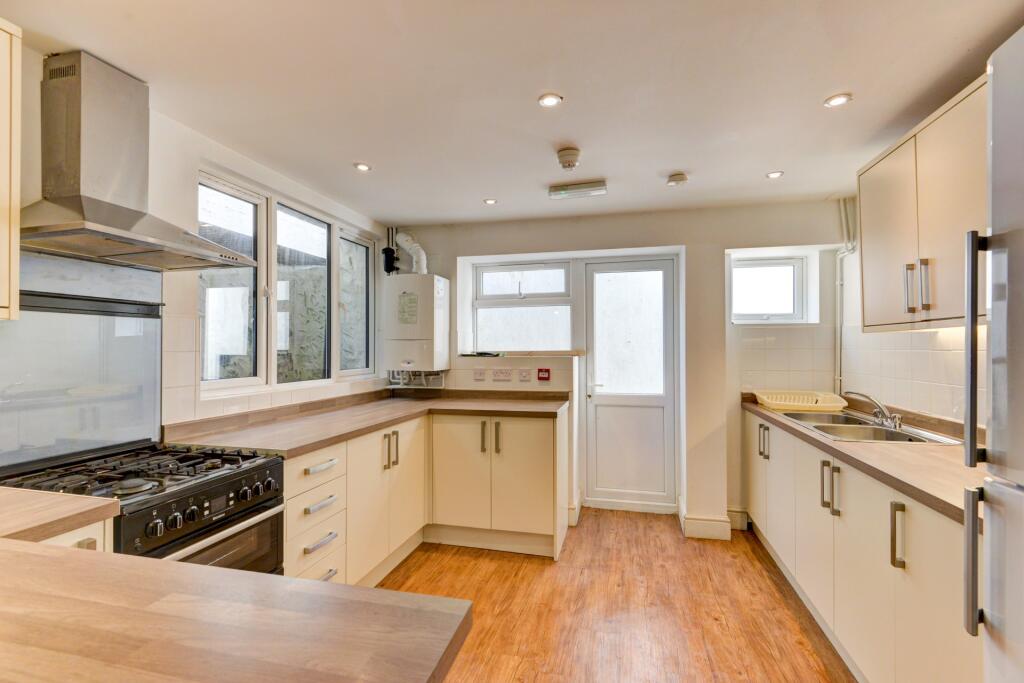 Bright and modern kitchen featuring ample count...
