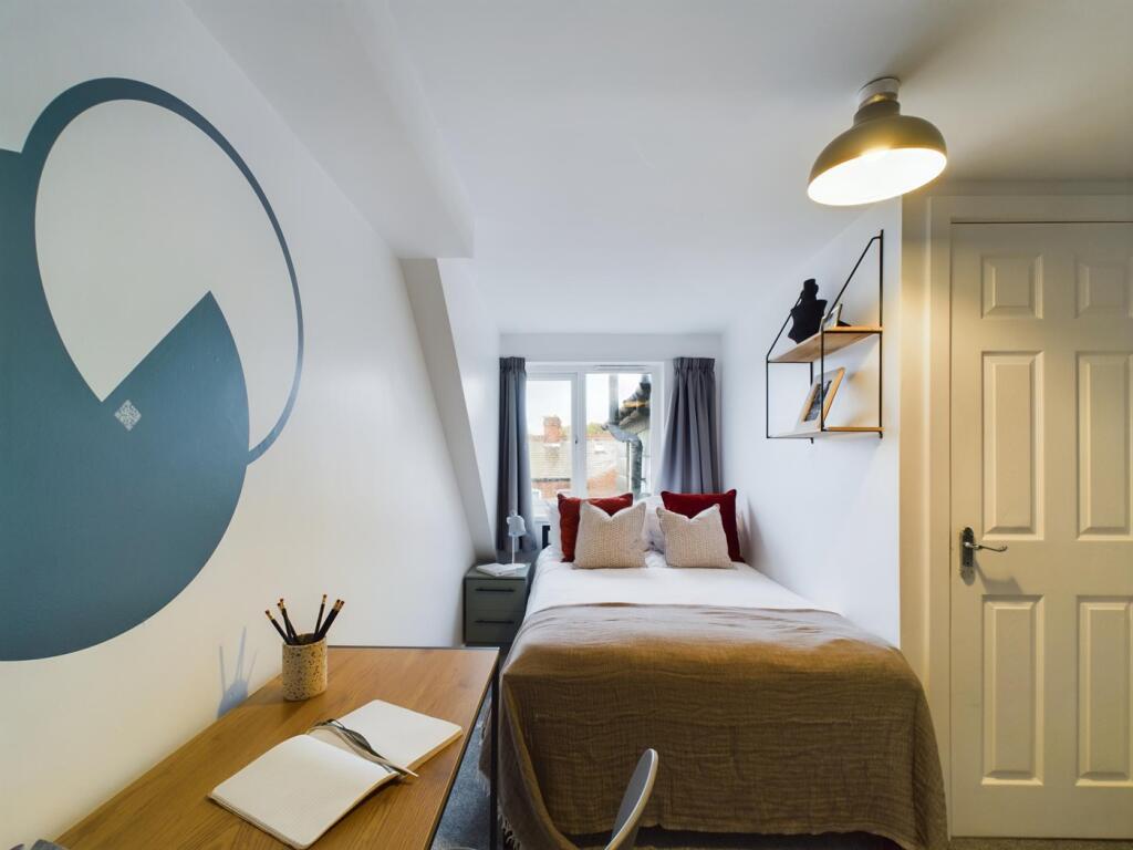 A stylish and well-lit double bedroom featuring...