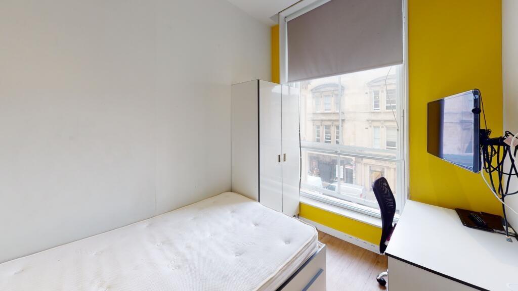 Bright and welcoming bedroom with a large windo...