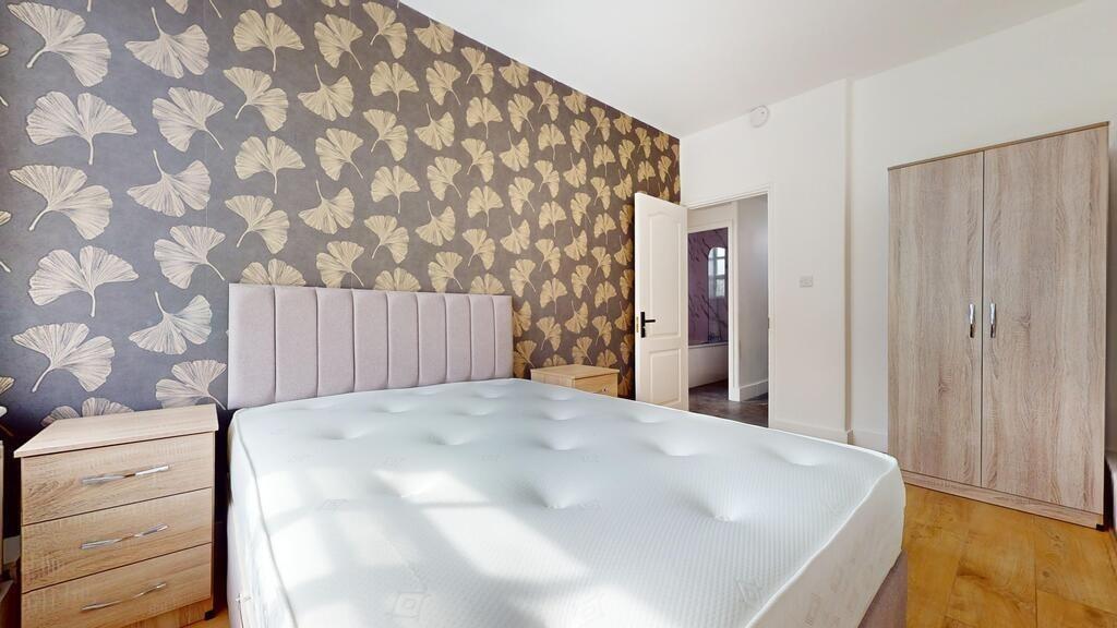 Bright double bedroom featuring a comfortable u...