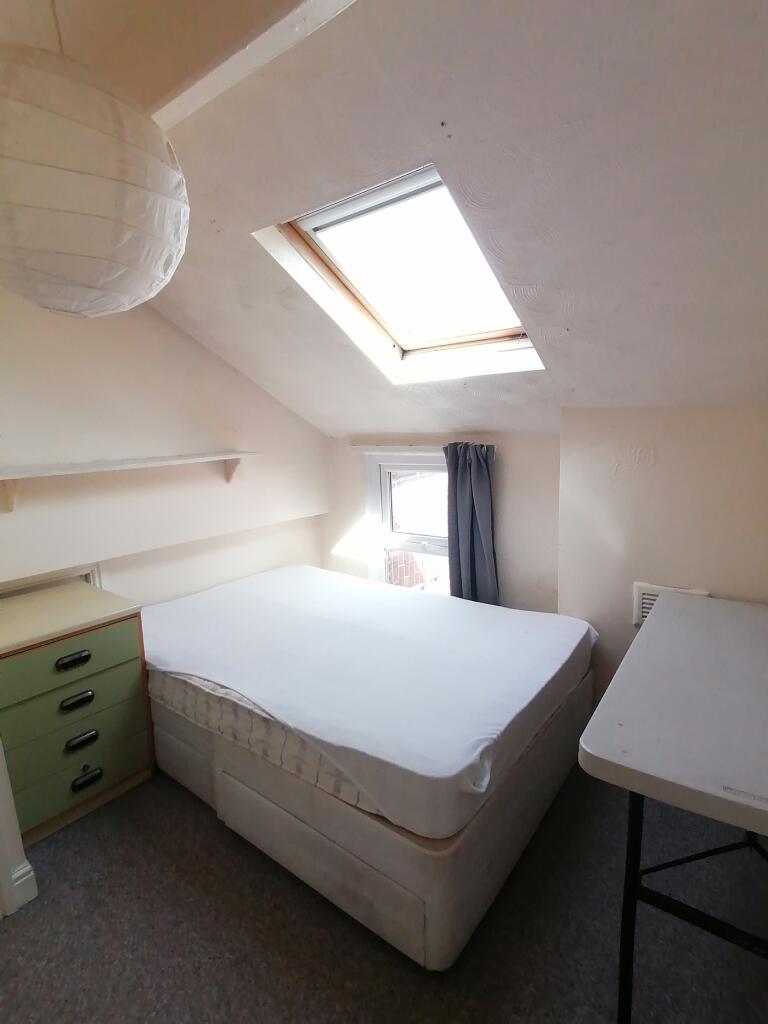 A bright and inviting double bedroom featuring ...