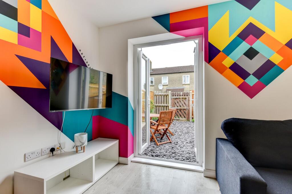 This vibrant living room features a striking wa...