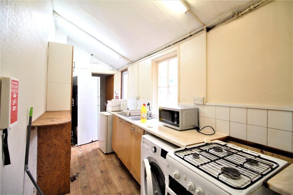 A compact kitchen featuring essential appliance...