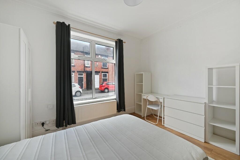 Bright and airy double bedroom featuring a larg...