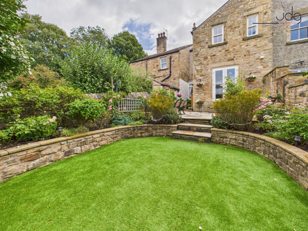 Rear view of the property and gardens