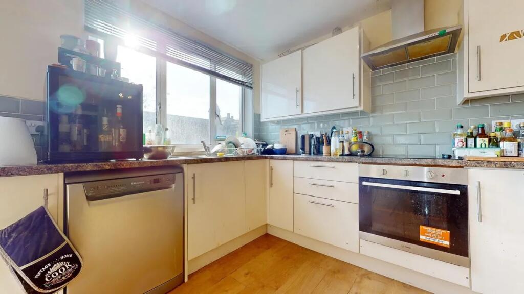 Bright and modern kitchen featuring ample cabin...