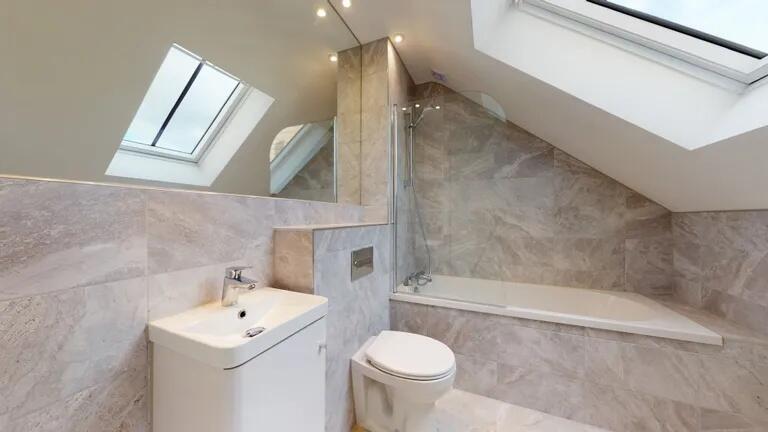 A stylish bathroom suite featuring a modern bat...