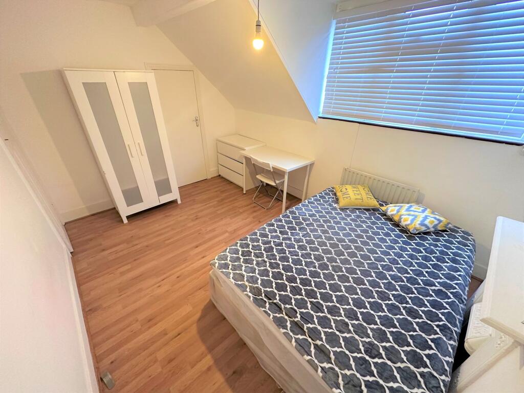 Bright double bedroom featuring a cozy double b...