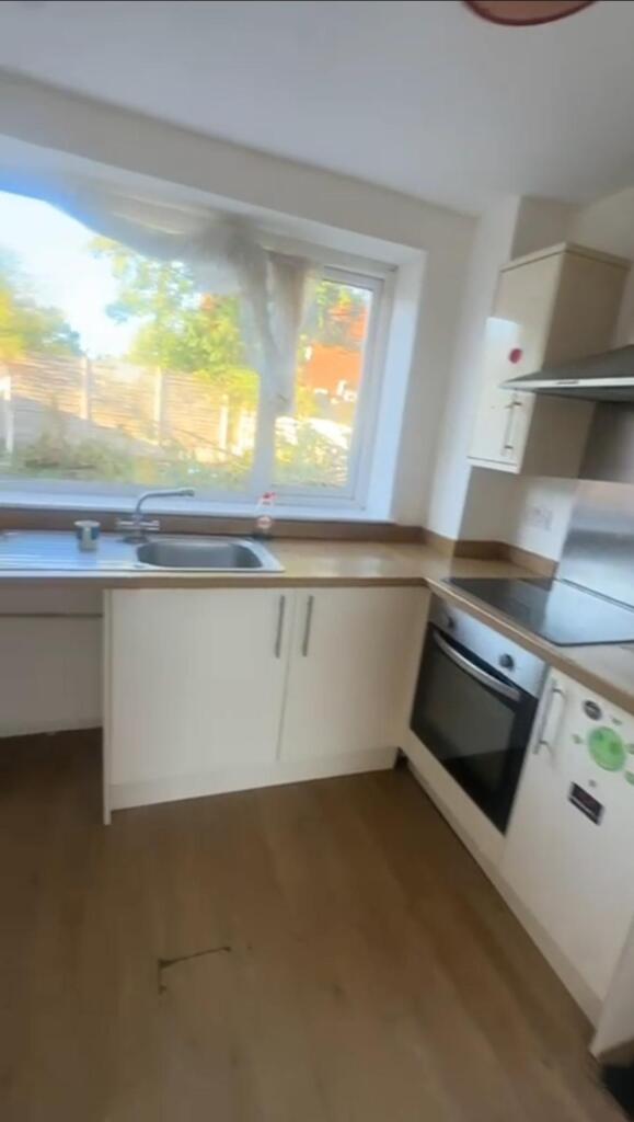 A bright and functional kitchen with a large wi...