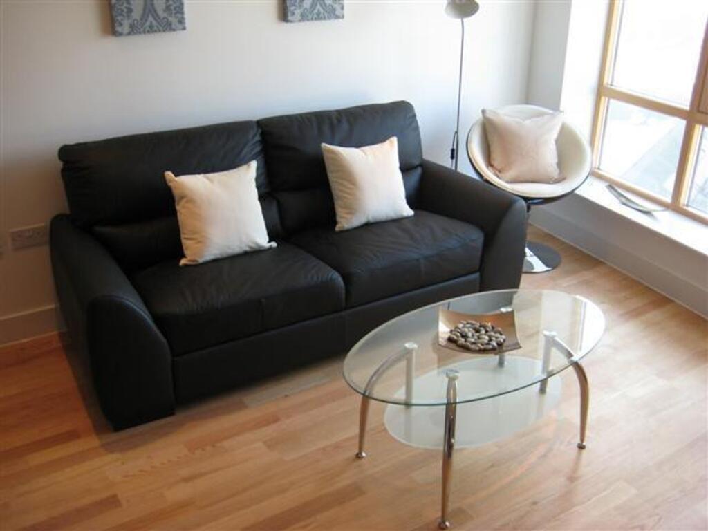 A stylish living room featuring a comfortable b...