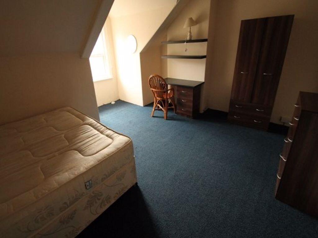 Cozy single bedroom featuring a comfortable mat...