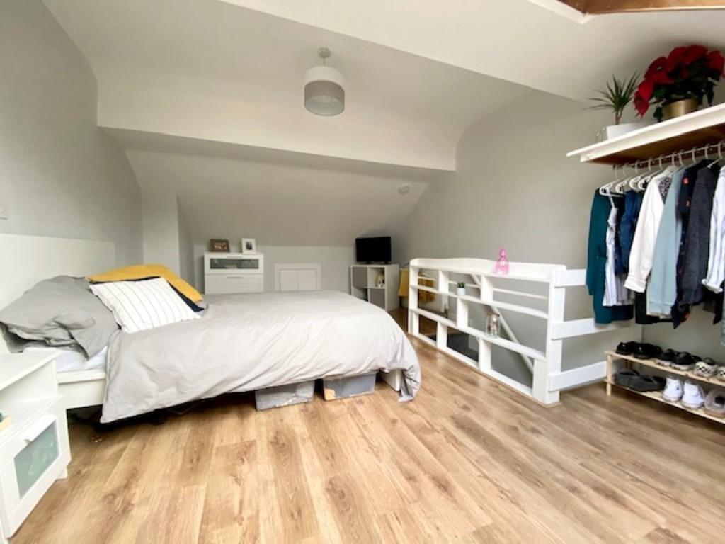 A bright and spacious master bedroom featuring ...