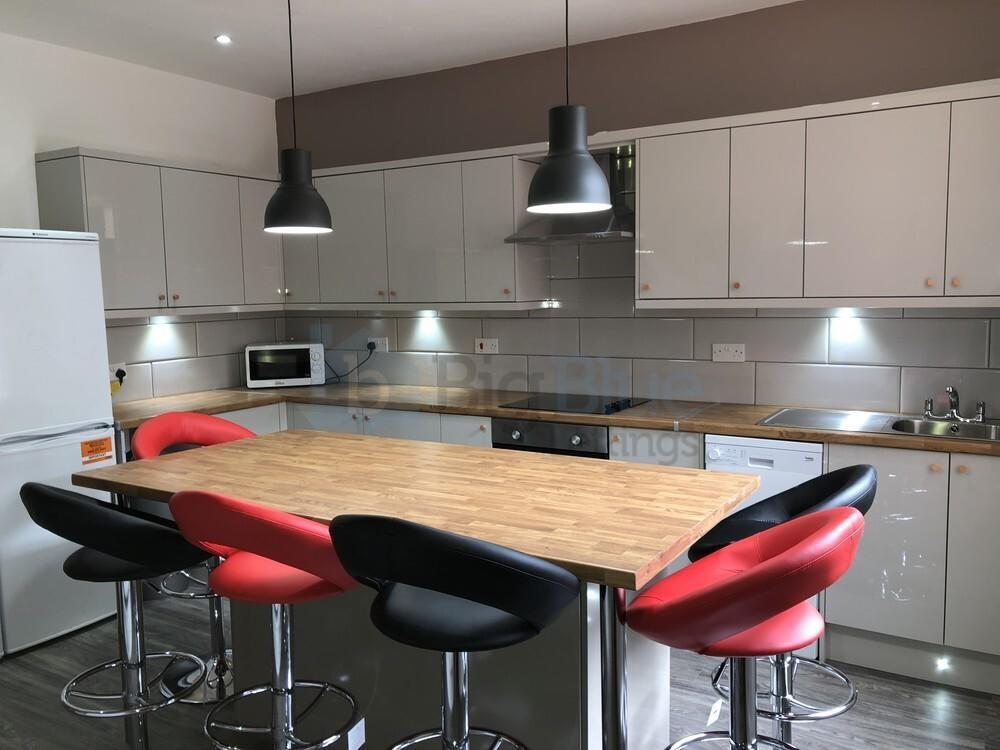 Bright and modern kitchen featuring a large woo...