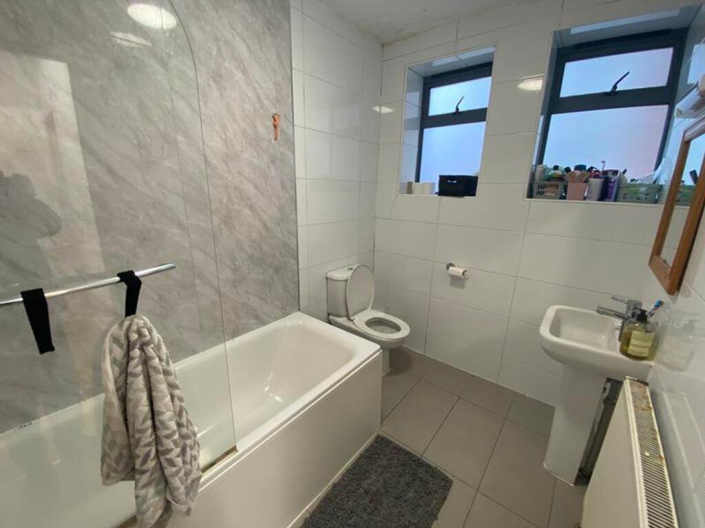 A modern and clean bathroom featuring a bath an...