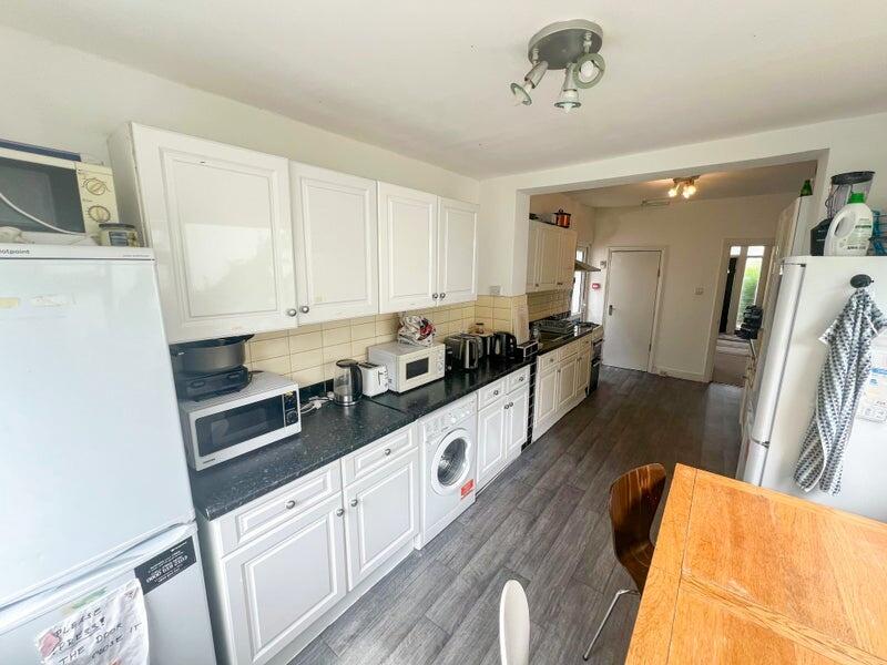 Bright and modern kitchen featuring ample cabin...