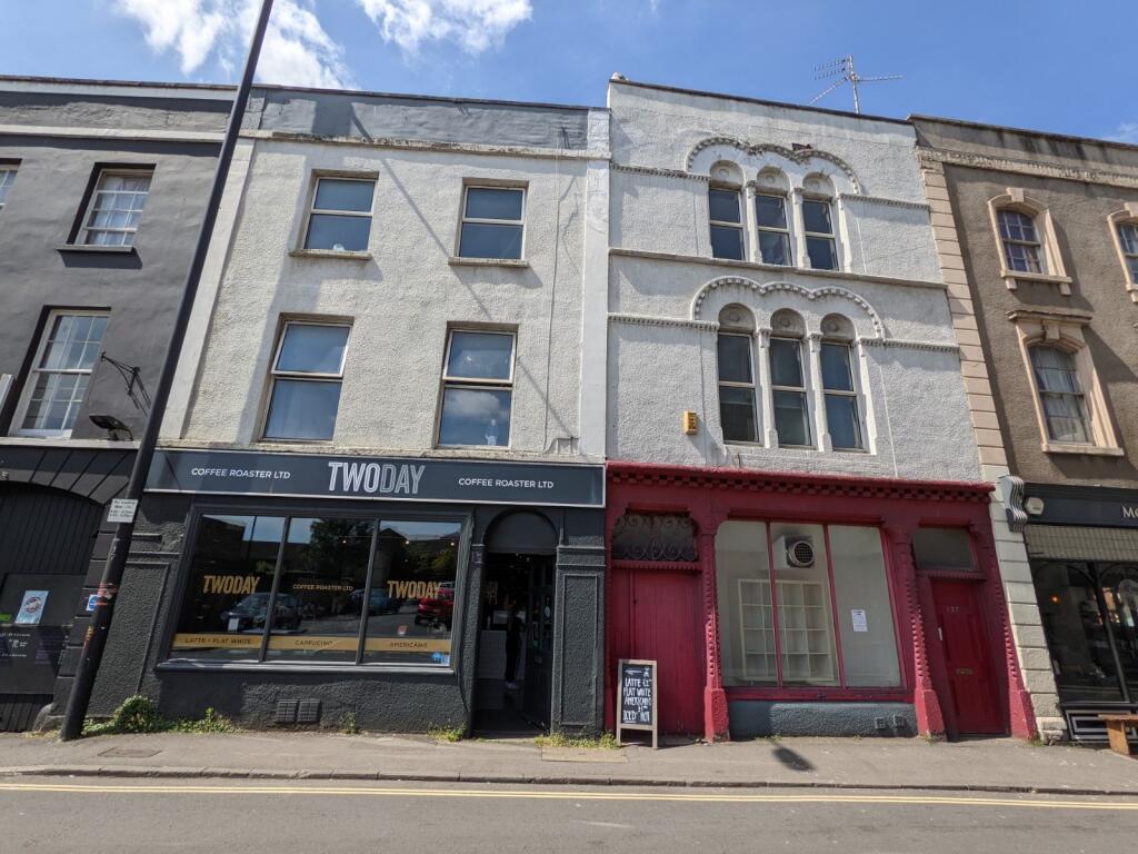 Traditional terraced shopfronts on a sunny stre...