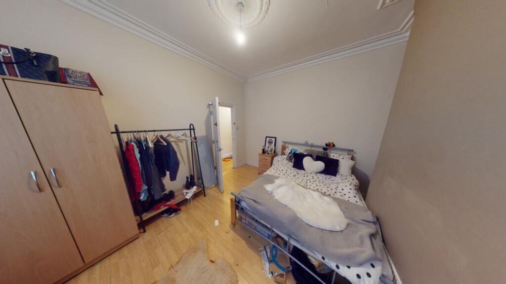 A spacious and well-lit double bedroom featurin...