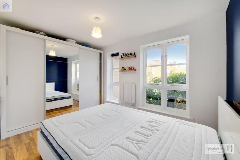 Bedroom with fitted, mirrored wardrobe