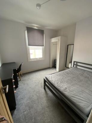 Bright and clean double bedroom featuring a lar...
