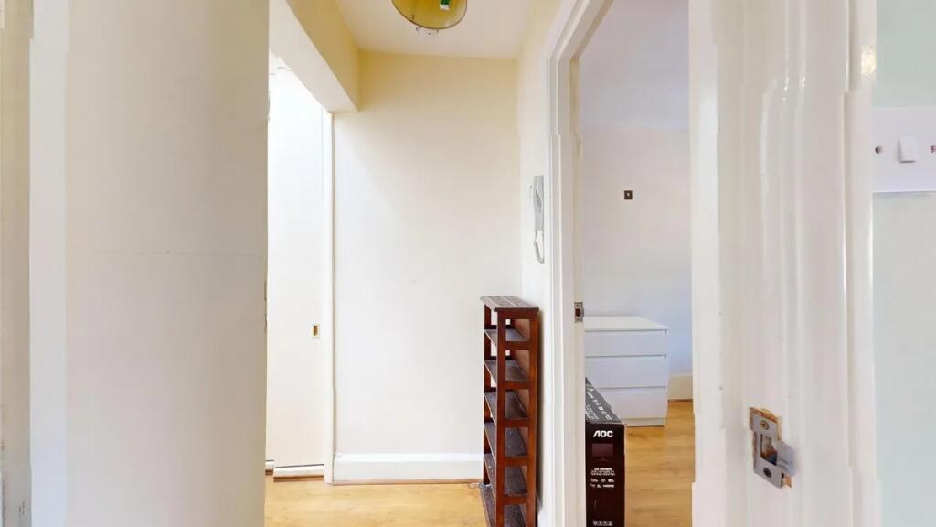 A bright and tidy hallway with light-colored wa...