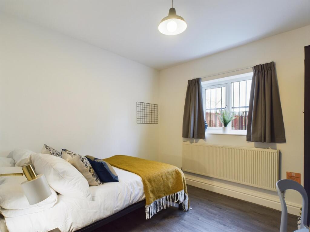 A bright and inviting double bedroom featuring ...