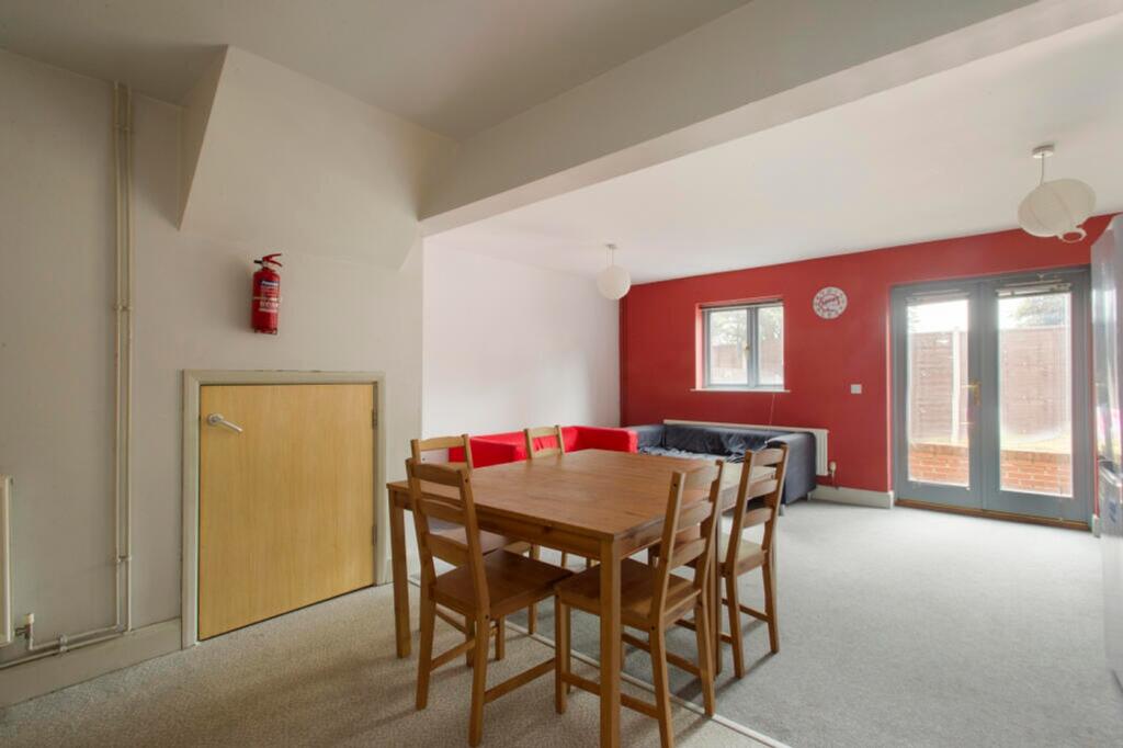 A spacious communal lounge featuring a cozy din...
