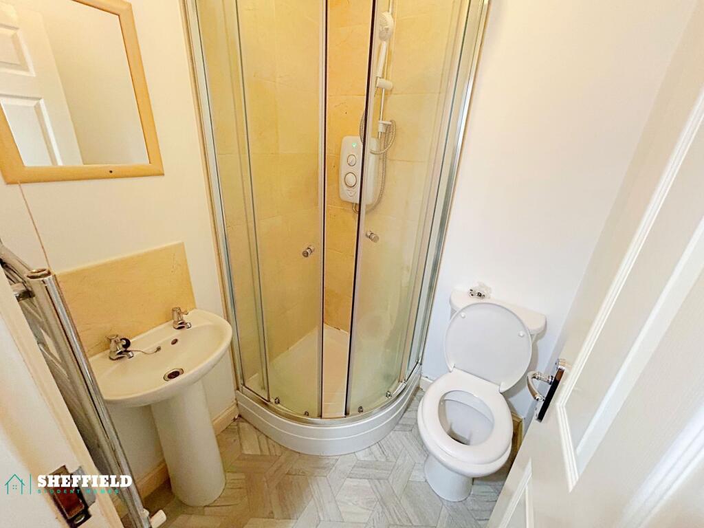 Bright, tidy ensuite bathroom with a corner sho...