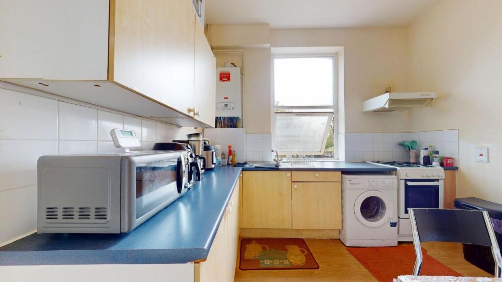 A bright and functional kitchen featuring a blu...