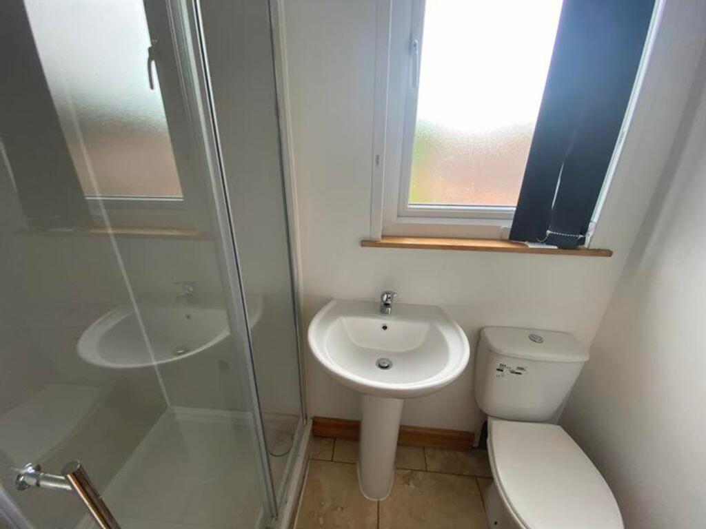 A bright and tidy bathroom featuring a modern s...