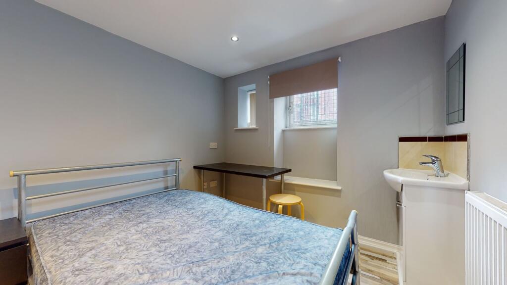 Bright and cozy double bedroom featuring a meta...