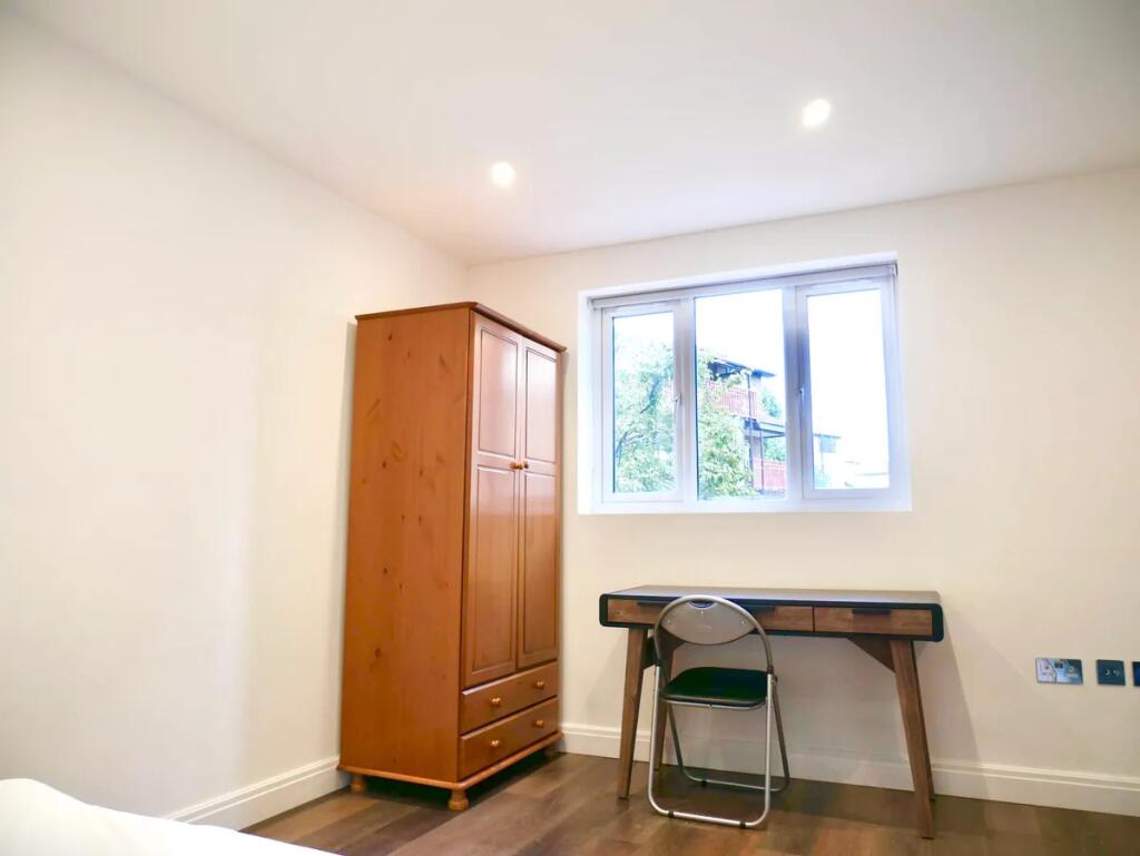 Bright and tidy single bedroom featuring a larg...