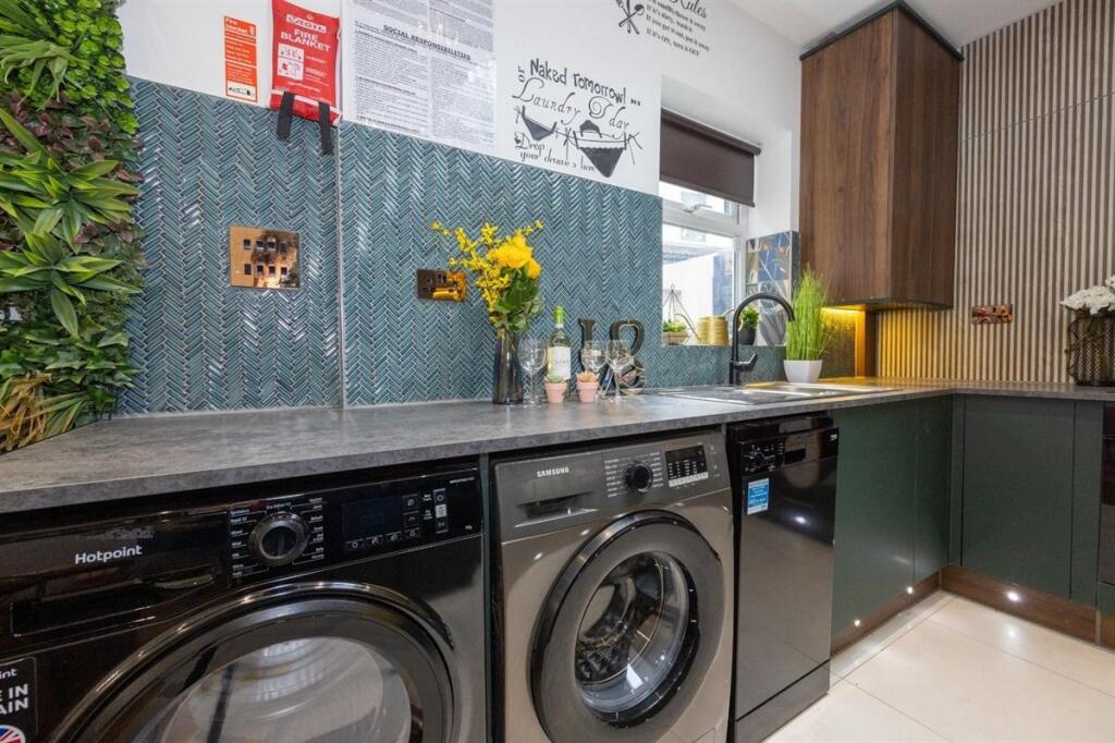 A modern kitchen featuring sleek cabinetry and ...