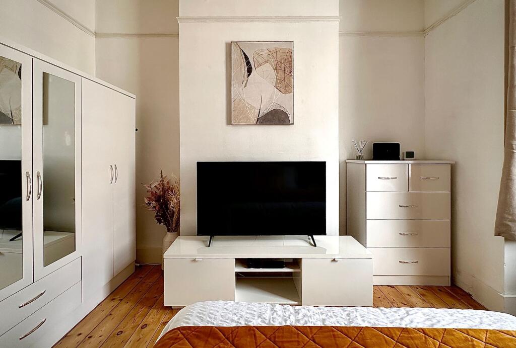 A bright and tidy double bedroom featuring a sl...