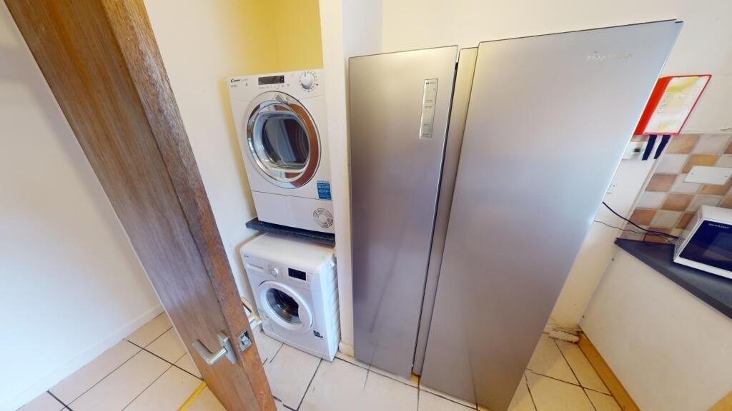 A compact and tidy kitchen area featuring moder...