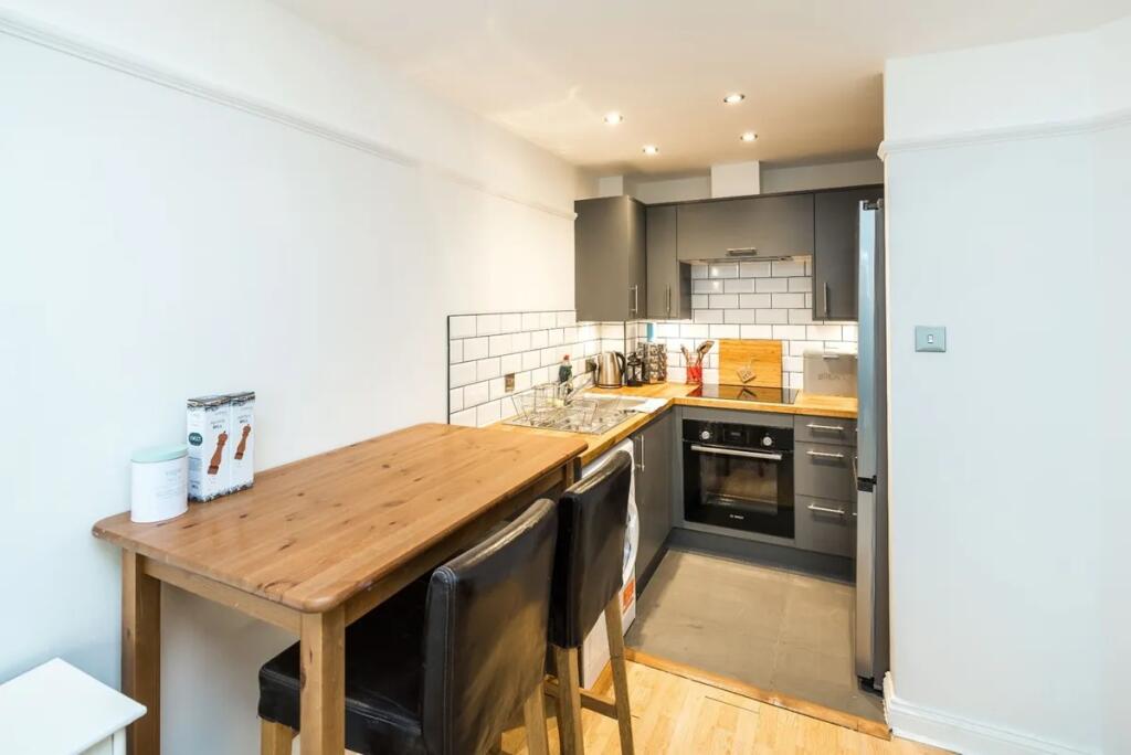 Modern kitchen with a stylish wooden breakfast ...