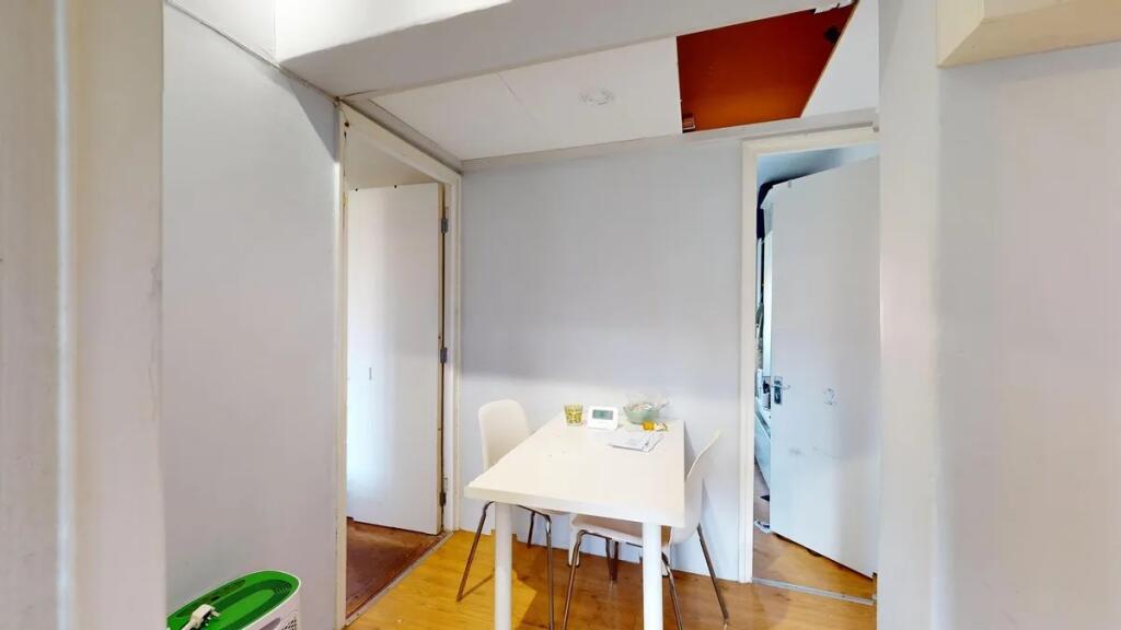 A simple communal workspace featuring a white t...