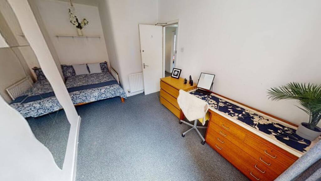 A bright and inviting double bedroom featuring ...