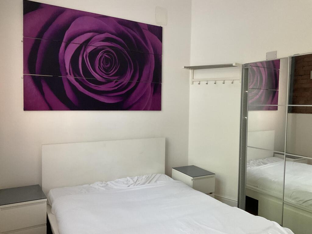 A bright and tidy double bedroom featuring a co...