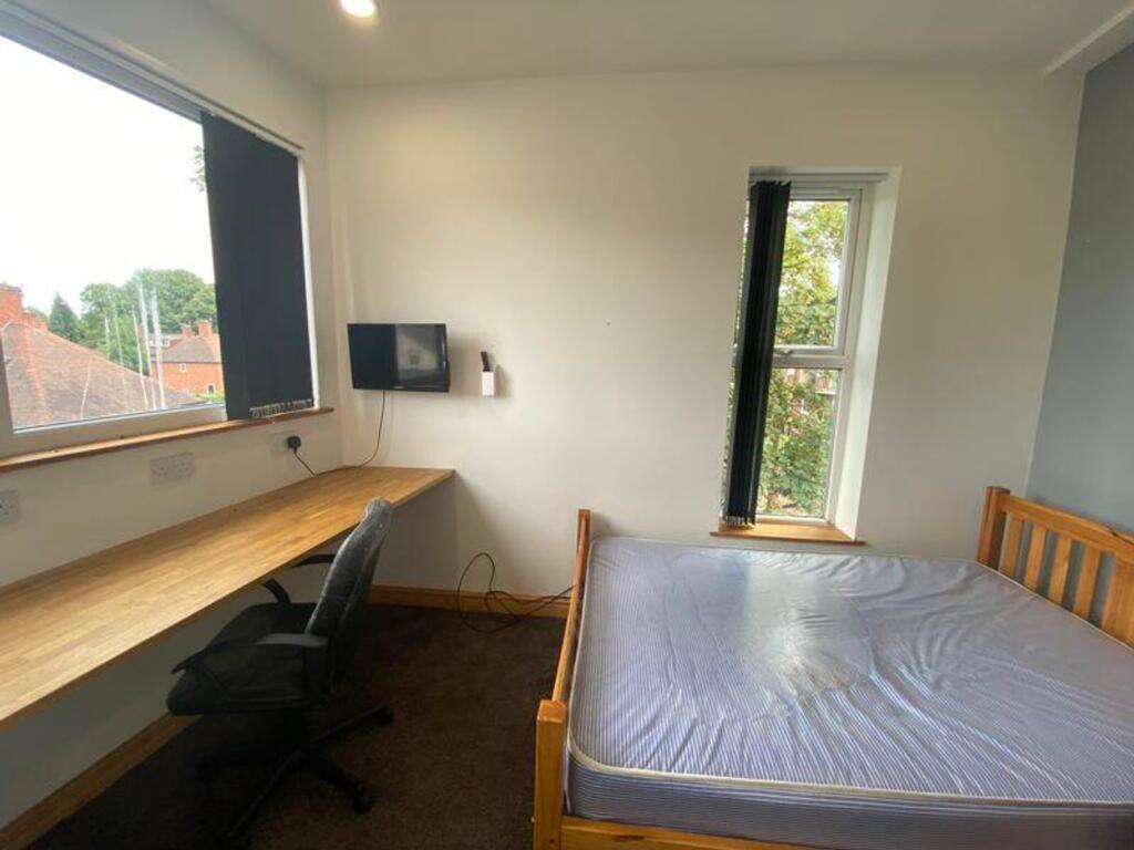 A bright and inviting double bedroom featuring ...