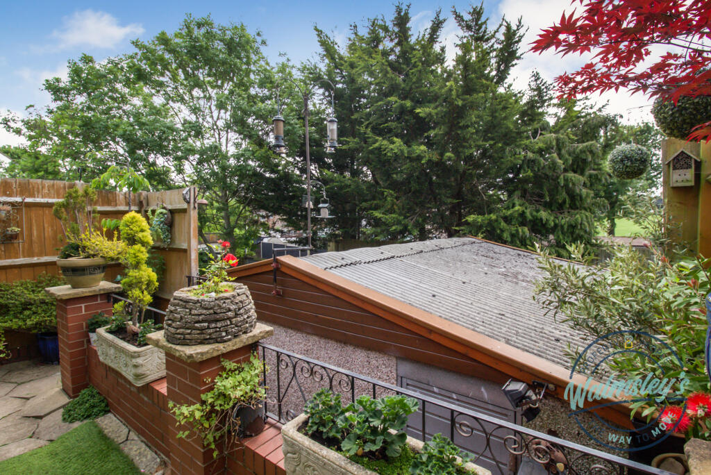 Double garage down steps from terraced garden